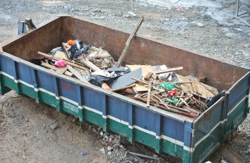Cluttered garage being cleared by professionals in Wembley